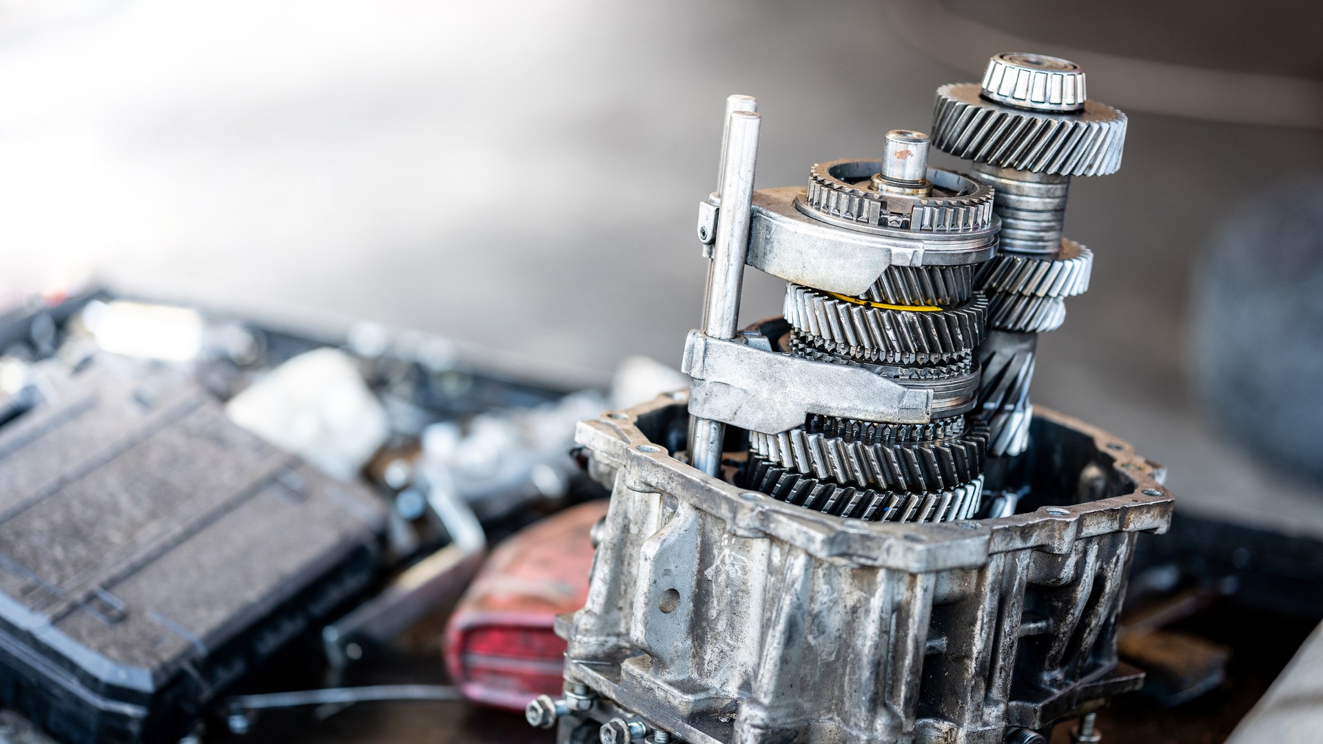 Car automatic transmission gear part on workbench in garage