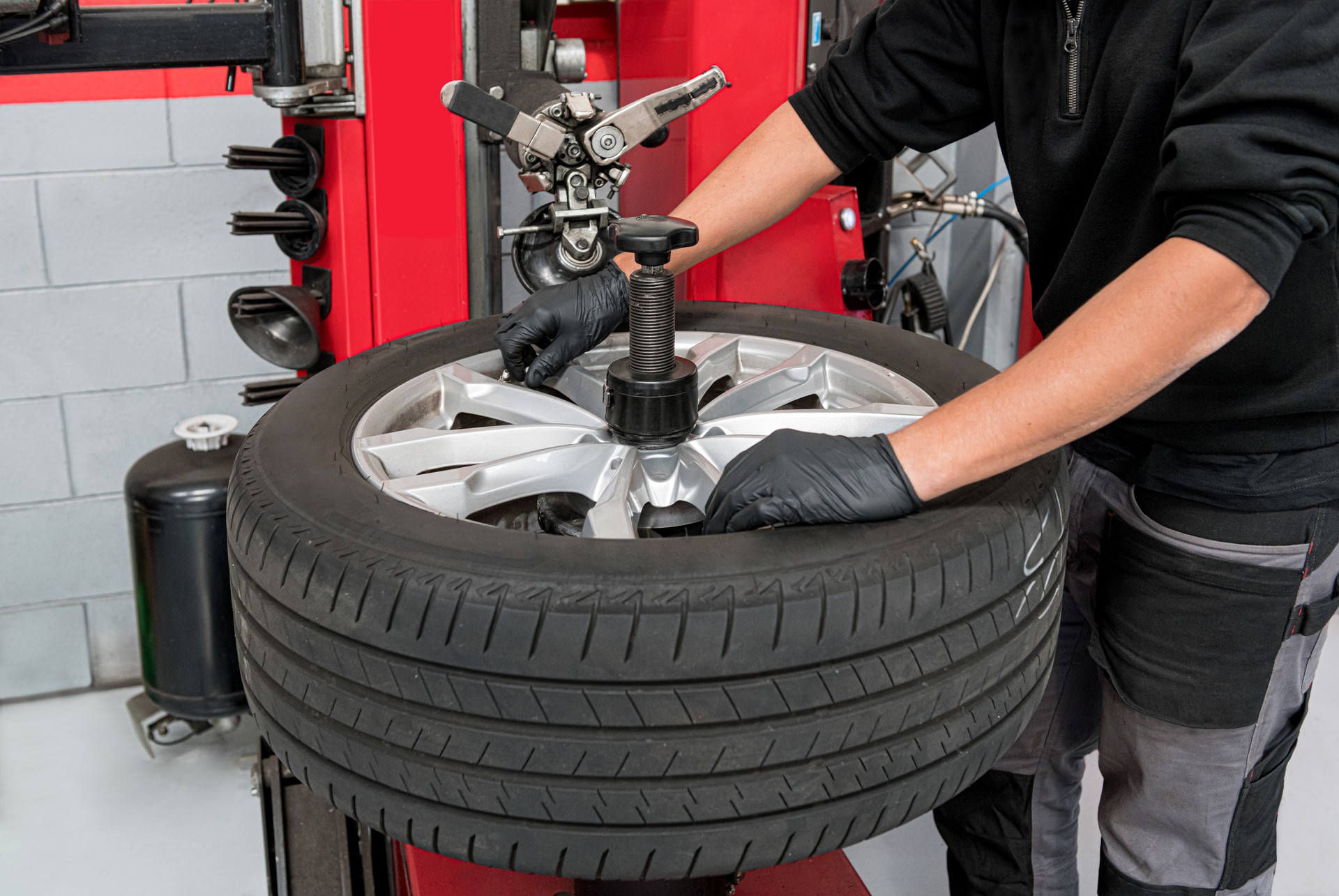 Male operator dismantling tire during work